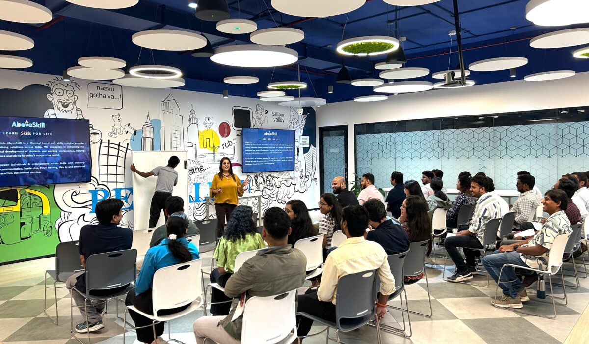Professionals engaged in soft skills training session under modern ceiling