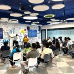 Professionals engaged in soft skills training session under modern ceiling