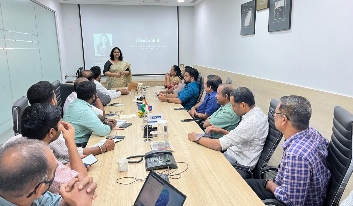 Managers attending leadership training program at conference table in India