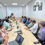 Managers attending leadership training program at conference table in India